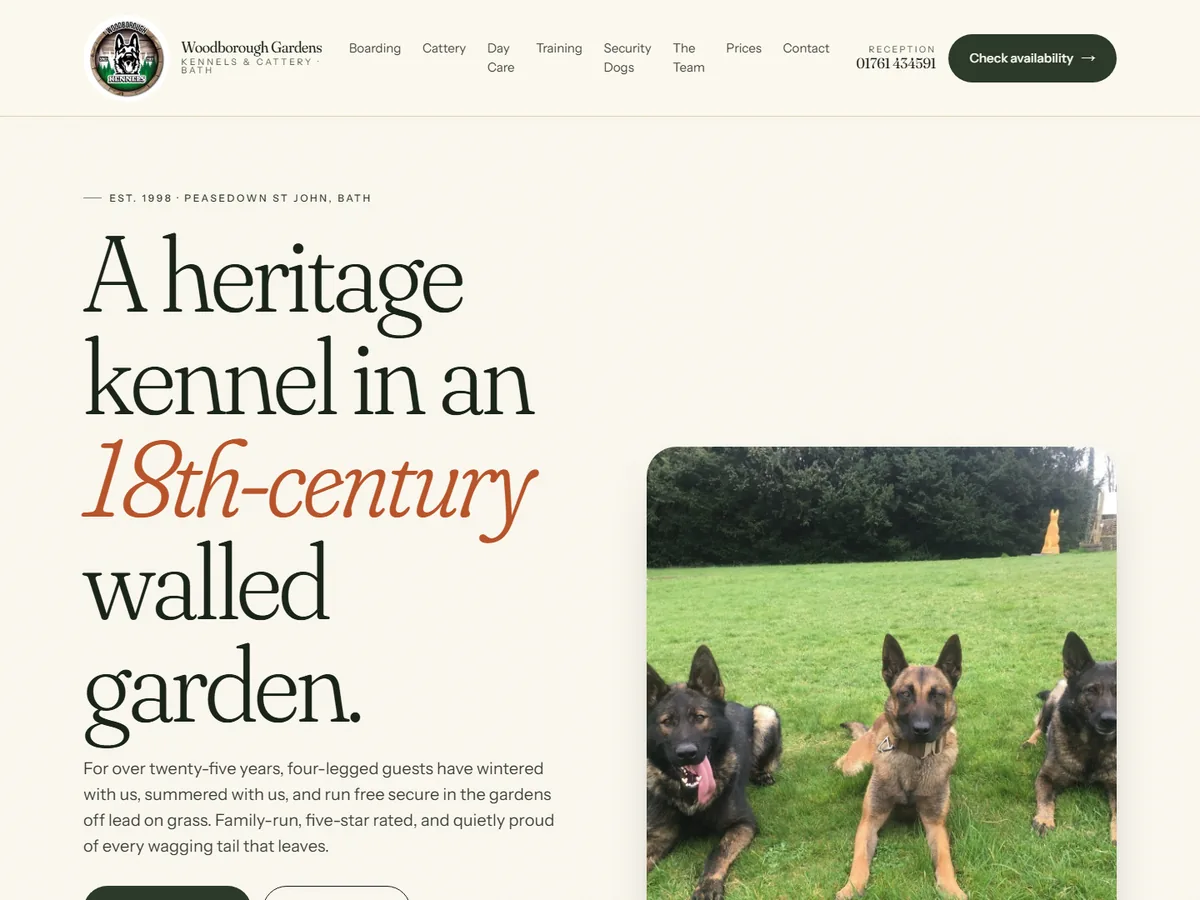 Woodborough Gardens Kennels homepage — serif headline "A heritage kennel in an 18th-century walled garden" beside a photo of dogs on the lawn.